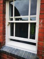 Replaced lower sections of a sash window in primer
