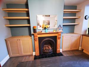 Flanking Victorian shaker style cupboards and shelves