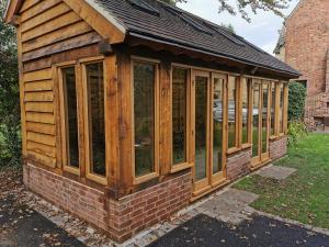 Fitting glazing and doors to oak garden building