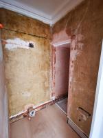 Ensuite bathroom in 1820's property going through refurbishment, walls stripped, floor laid in ply, ready for plastering