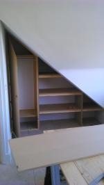 Wardrobe and storage built into the roof pitch of a loft