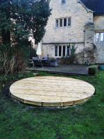 Circular decking being formed in the garden of a 17th century property