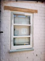 Wooden window casement repaired with new oak lintel
