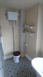 Victorian toilet set-up with pipework boxed