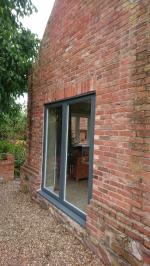 Full-house window and doorframe replacement, fitting softwood stormproof window casements and oak external doors.