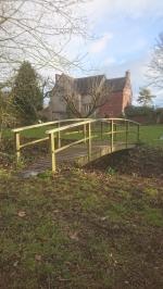 Replacement pressure treated redwood handrails for garden brook bridge
