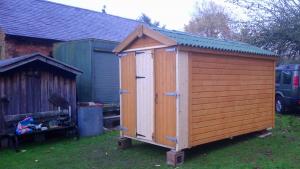 Garden shed extended and widened to house tractor